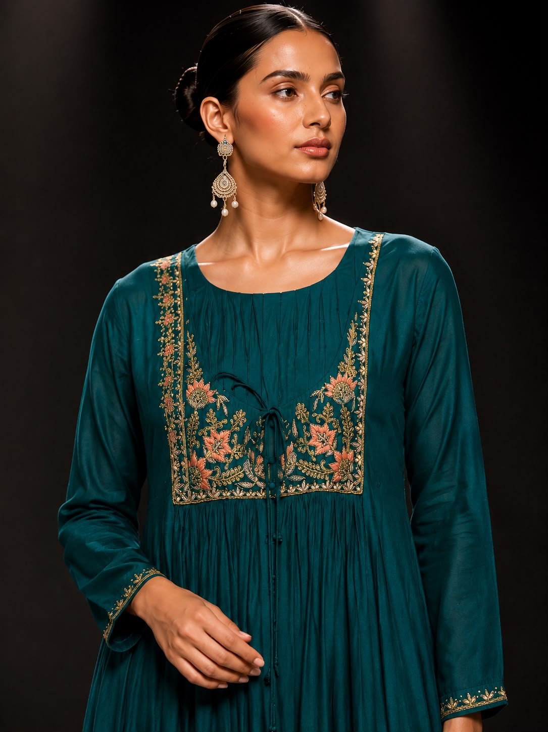 green cu Emerald green muslin silk straight kurta set with embroidered floral yoke, straight-leg pants, and embroidered soft net dupatta for festive and wedding wear.