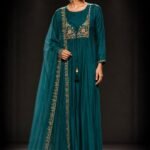 Emerald green muslin silk straight kurta set with embroidered floral yoke, straight-leg pants, and embroidered soft net dupatta for festive and wedding wear.